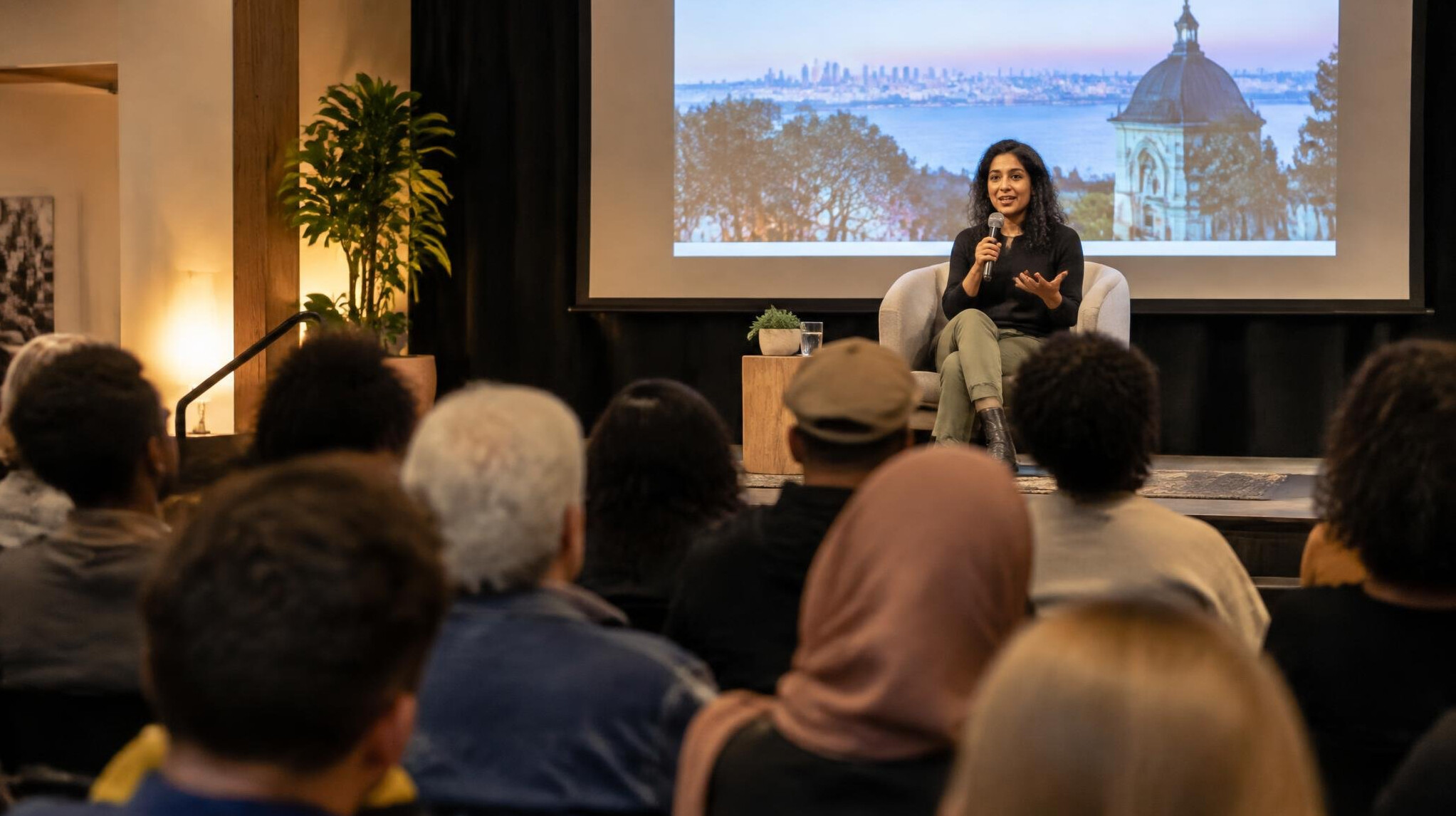 Speaker on stage in front of a public audience