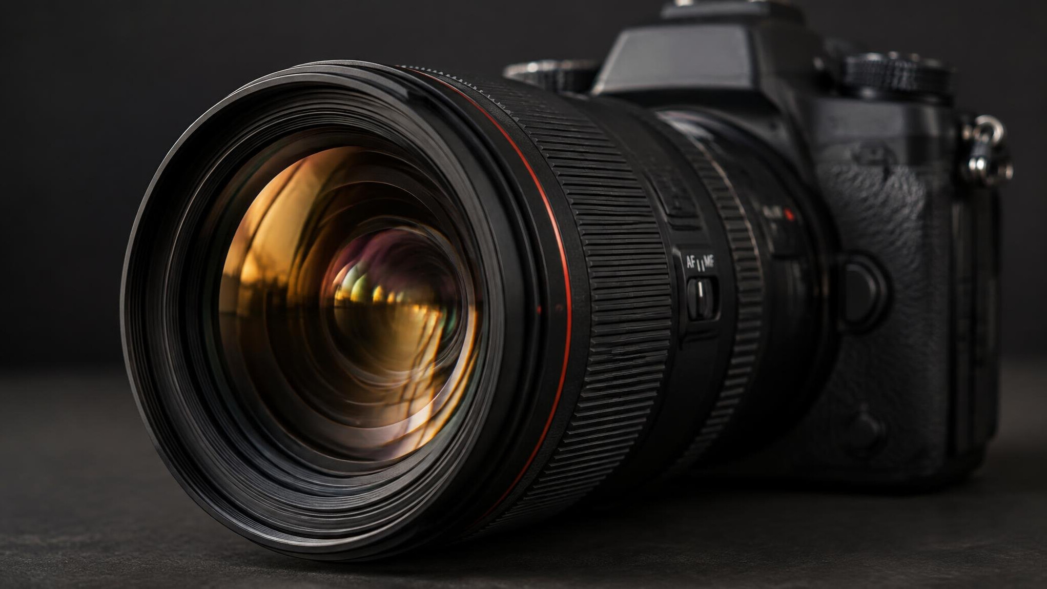 Close-up of a camera lens with warm reflections